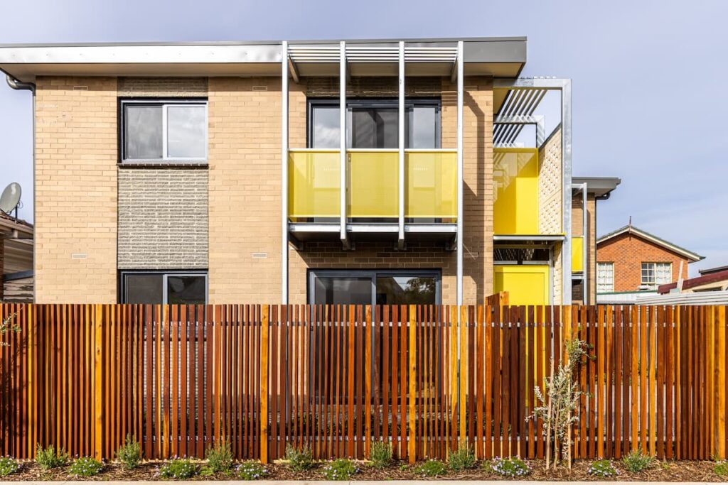 The facade of 47 Union Street, a block of flats with a brick exterior and highlights of yellow for doors and balconies.